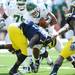 Michigan junior safety Brandin Hawthorne tackles Eastern ball carrier, running back Joe Flemming during the first half against Eastern Michigan at Michigan Stadium on Saturday. Melanie Maxwell I AnnArbor.com